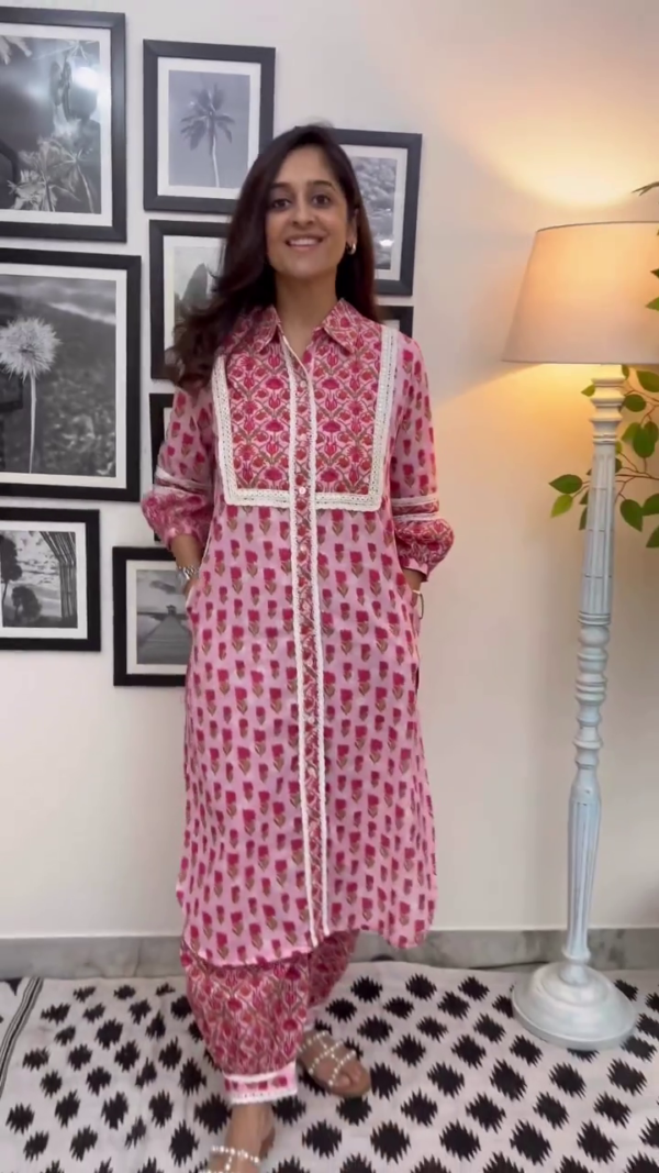 Pink Floral Printed Cotton Kurta Set with Intricate Yoke Detailing, Lace Accents, Pockets, and Matching Printed Pants Perfect for Casual and Festive Wear