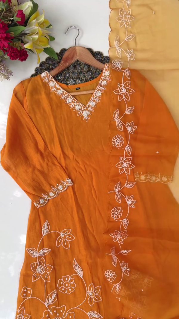 Bright Mustard Orange Cotton Straight-Cut Suit Set with White Floral Thread Embroidery on Neckline, Sleeves, and Hem, Paired with Matching Bottoms and Sheer Organza Dupatta with Delicate Embroidered Floral Border