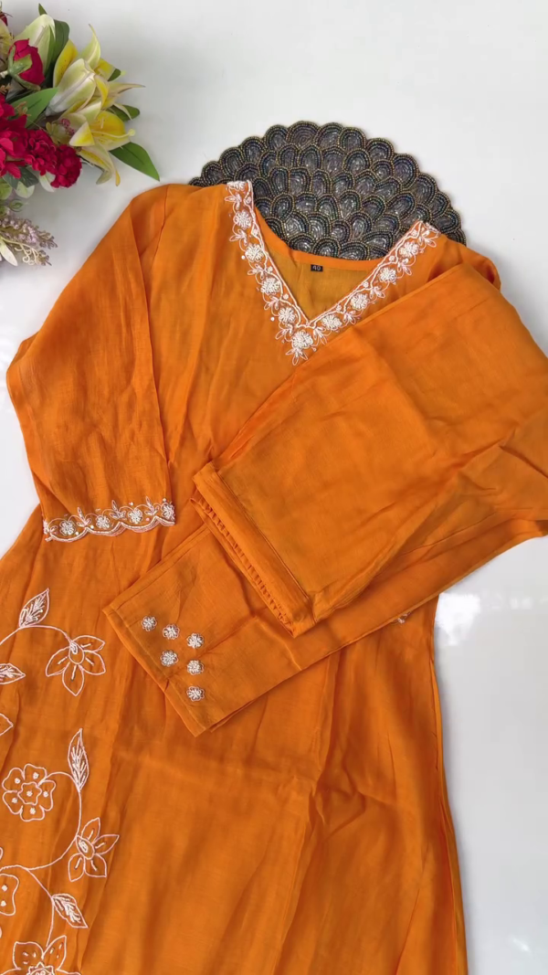 Bright Mustard Orange Cotton Straight-Cut Suit Set with White Floral Thread Embroidery on Neckline, Sleeves, and Hem, Paired with Matching Bottoms and Sheer Organza Dupatta with Delicate Embroidered Floral Border - Image 2