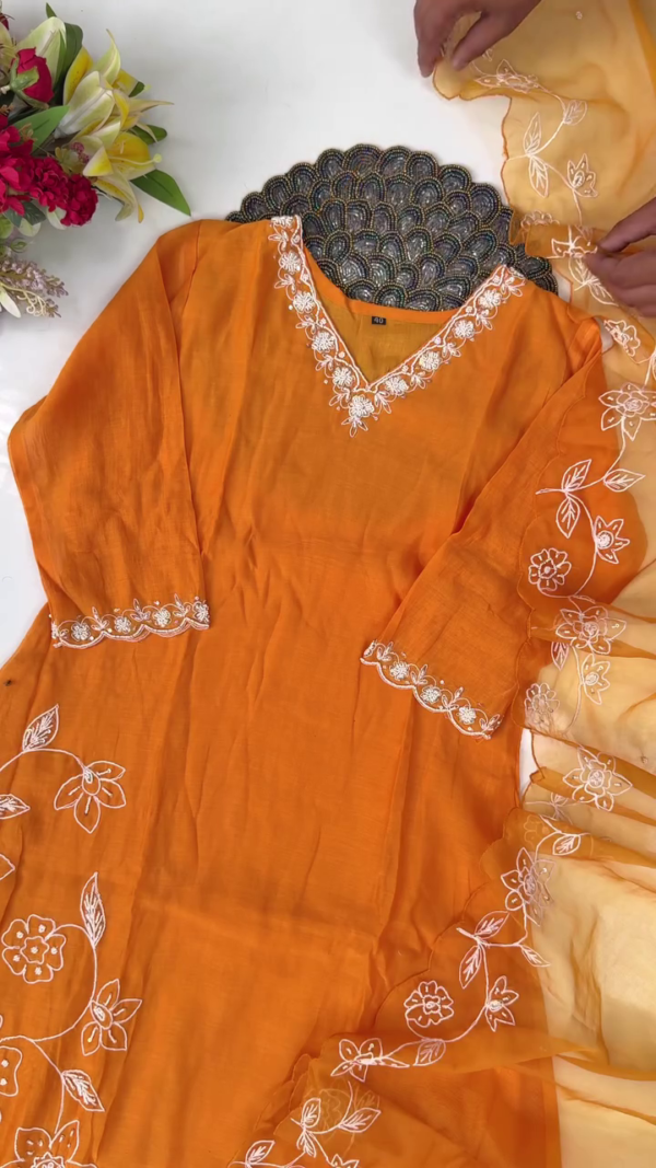 Bright Mustard Orange Cotton Straight-Cut Suit Set with White Floral Thread Embroidery on Neckline, Sleeves, and Hem, Paired with Matching Bottoms and Sheer Organza Dupatta with Delicate Embroidered Floral Border - Image 3
