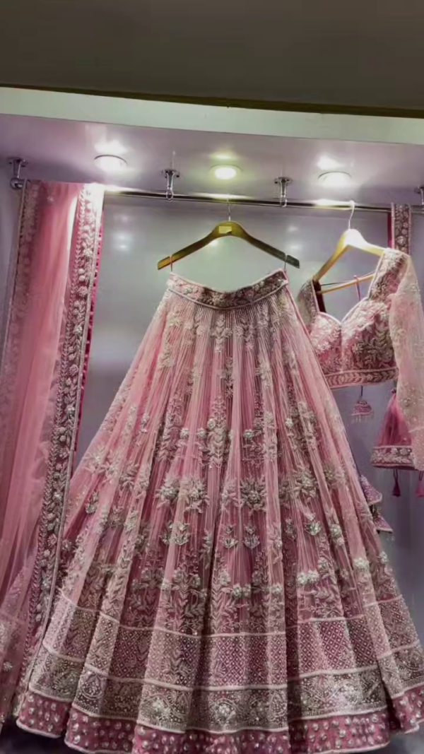 Pink Heavy Embroidered Net Bridal Lehenga Choli with Intricate Floral and Zari Work, Featuring a Graceful Flowing Skirt, Embellished Dupatta, and Stunning Blouse, Perfect for Weddings and Special Occasions