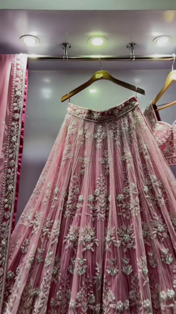 Pink Heavy Embroidered Net Bridal Lehenga Choli with Intricate Floral and Zari Work, Featuring a Graceful Flowing Skirt, Embellished Dupatta, and Stunning Blouse, Perfect for Weddings and Special Occasions - Image 2