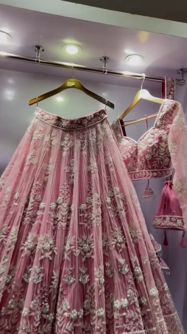 Pink Heavy Embroidered Net Bridal Lehenga Choli with Intricate Floral and Zari Work, Featuring a Graceful Flowing Skirt, Embellished Dupatta, and Stunning Blouse, Perfect for Weddings and Special Occasions - Image 3
