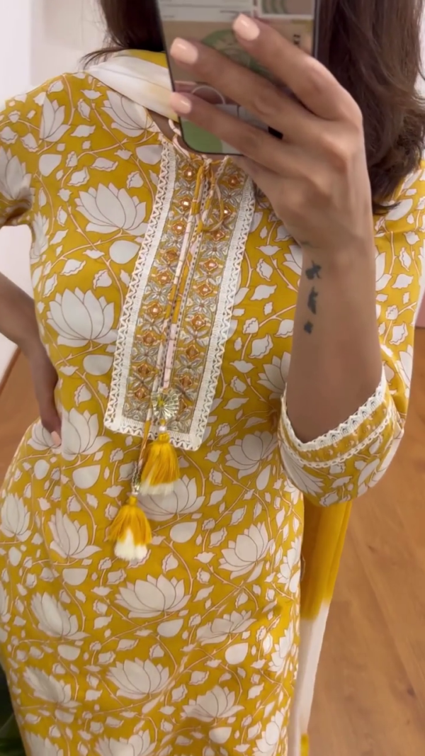 Bright Mustard Yellow Floral Printed Cotton Kurta Set for Women Featuring White Lotus Motif, Lace Detailing, Embroidered Neckline with Tassels, Matching Pants and Dupatta – Ideal for Festive and Everyday Ethnic Wear - Image 2