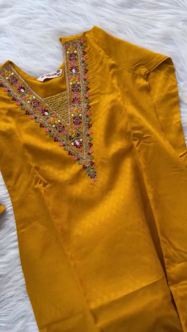 mustard yellow embroidered straight cut suit with intricate floral thread work on neckline and sleeves paired with matching bottoms and rich maroon Banarasi silk dupatta featuring traditional zari motifs and detailed border work