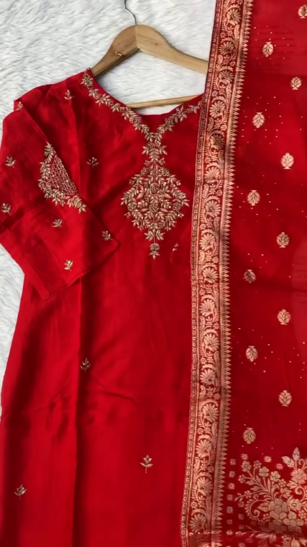 Rich red suit adorned with golden thread embroidery on the front and sleeves. Completed with a matching dupatta featuring an ornate floral border. - Image 2