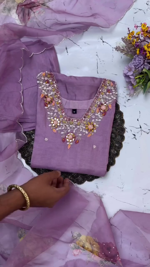 Elegant lavender suit with delicate sequin and thread embroidery around the neckline and sleeves. Paired with a floral-printed dupatta featuring scalloped edges for a graceful finish.