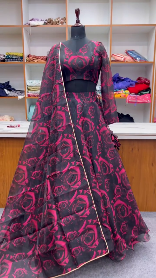 Bold Black & Red Rose-Print Organza Lehenga Set – Striking Sheer Sleeves, All-Over Floral Pattern & Light Dupatta with Gold Border – A Statement Look for Sangeet Nights, Receptions & Contemporary Festive Glam.