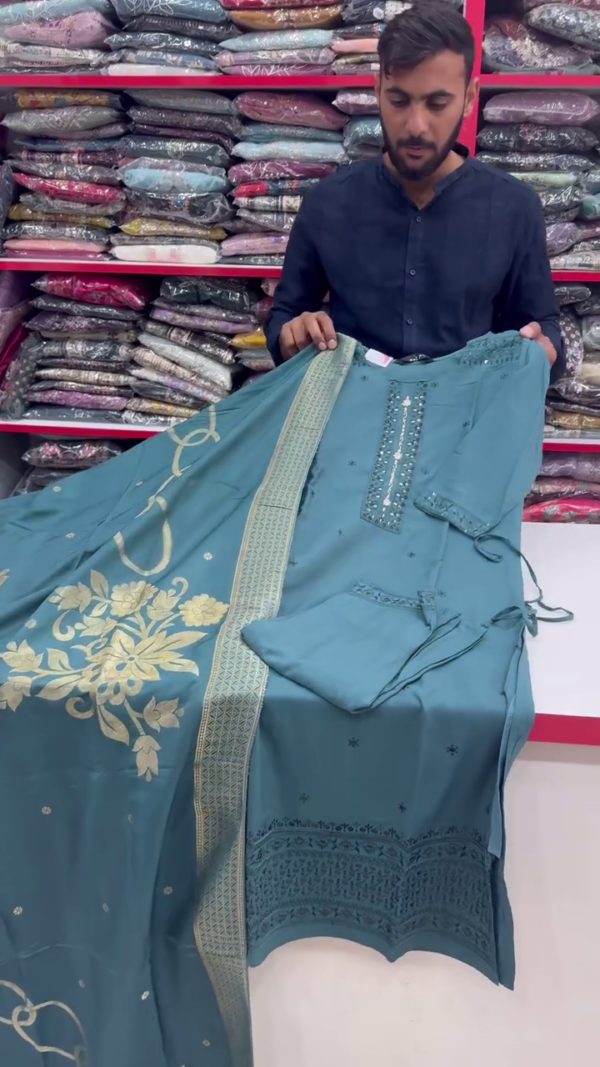 Teal Elegance – A Refined Three-Piece Suit in Deep Teal with Subtle Mirror Work on the Neckline, Delicate Embroidery on the Hem, and a Graceful Golden-Printed Dupatta for a Balanced Traditional Appeal. - Image 2