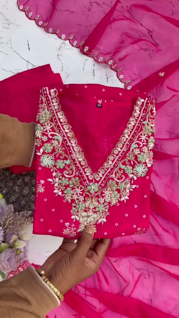 Bright pink suit with intricate silver-golden embroidery and mirror lace dupatta — a striking and festive choice.