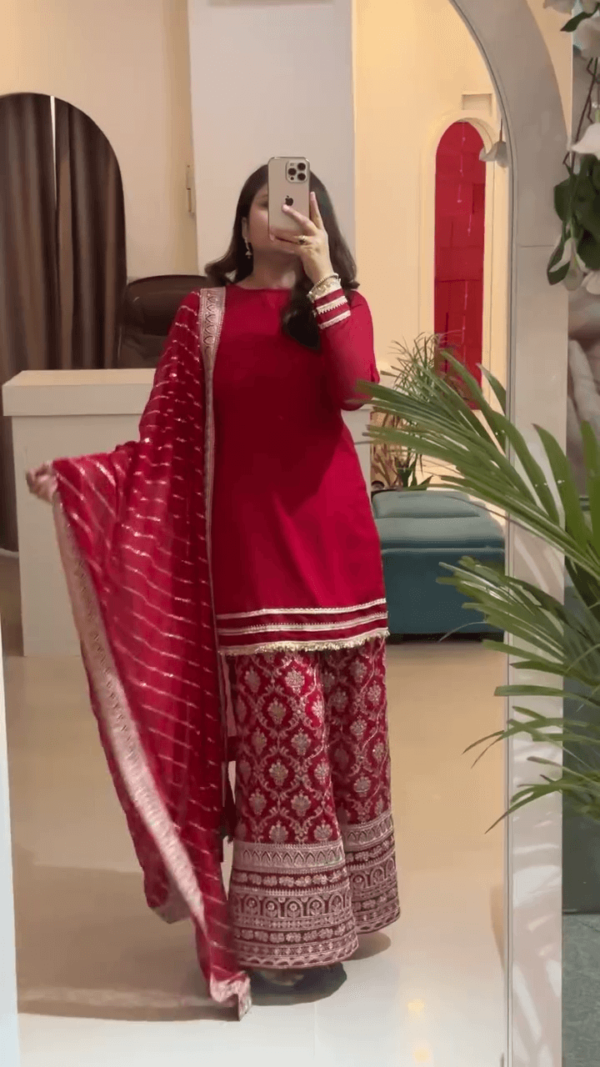 Traditional Red Salwar Kameez Set with Intricate Golden Embroidery, Paired with a Matching Printed Dupatta and Flared Bottoms