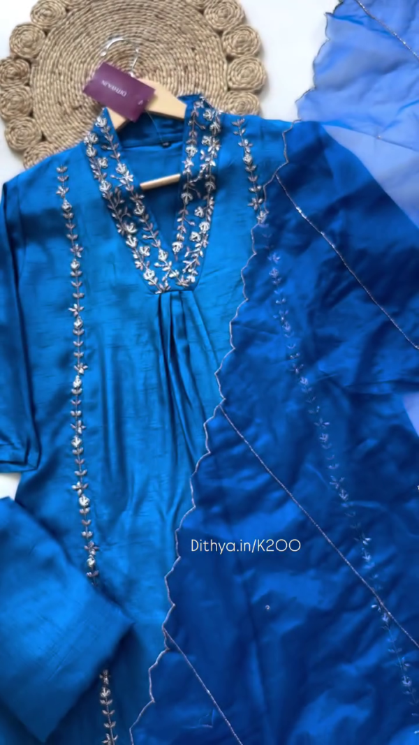 Royal Blue Silk-Blend Suit Set Featuring Intricate Silver Floral Embroidery on the Neckline and Panels – Paired with a Delicate Ruffled Organza Dupatta for an Elegant and Festive Ethnic Look - Image 2